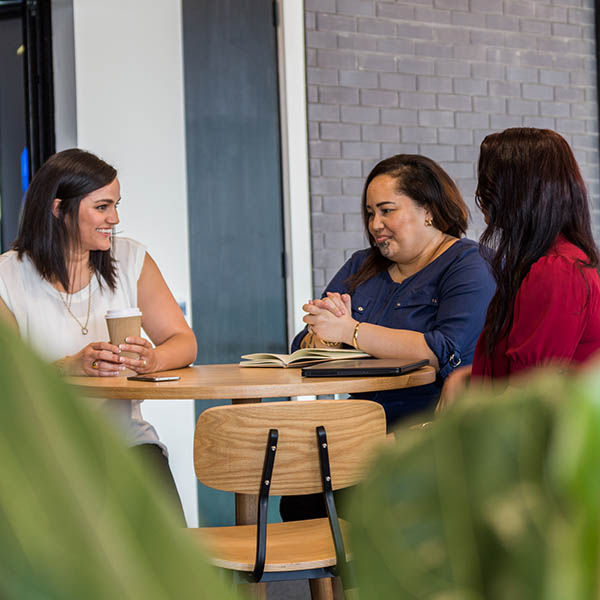 Three women sitting at a table